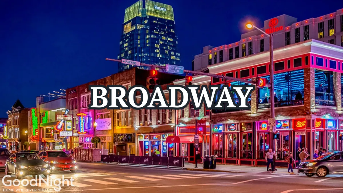 A bustling nighttime street scene in downtown Nashville, filled with vibrant neon signs, crowds of people enjoying the city’s energetic vibe, and tall buildings lining the block. The image captures diners, music lovers, and shoppers all mingling in a quintessential Nashville setting.