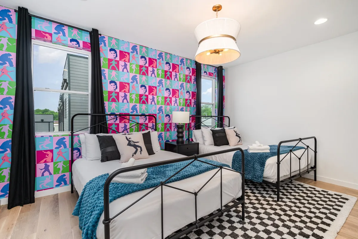 A vibrant bedroom scene with colorful wallpaper, playful bed frames, and decorative pillows. The energetic decor reflects creativity and comfort, providing a fun yet supportive space for restful nights.